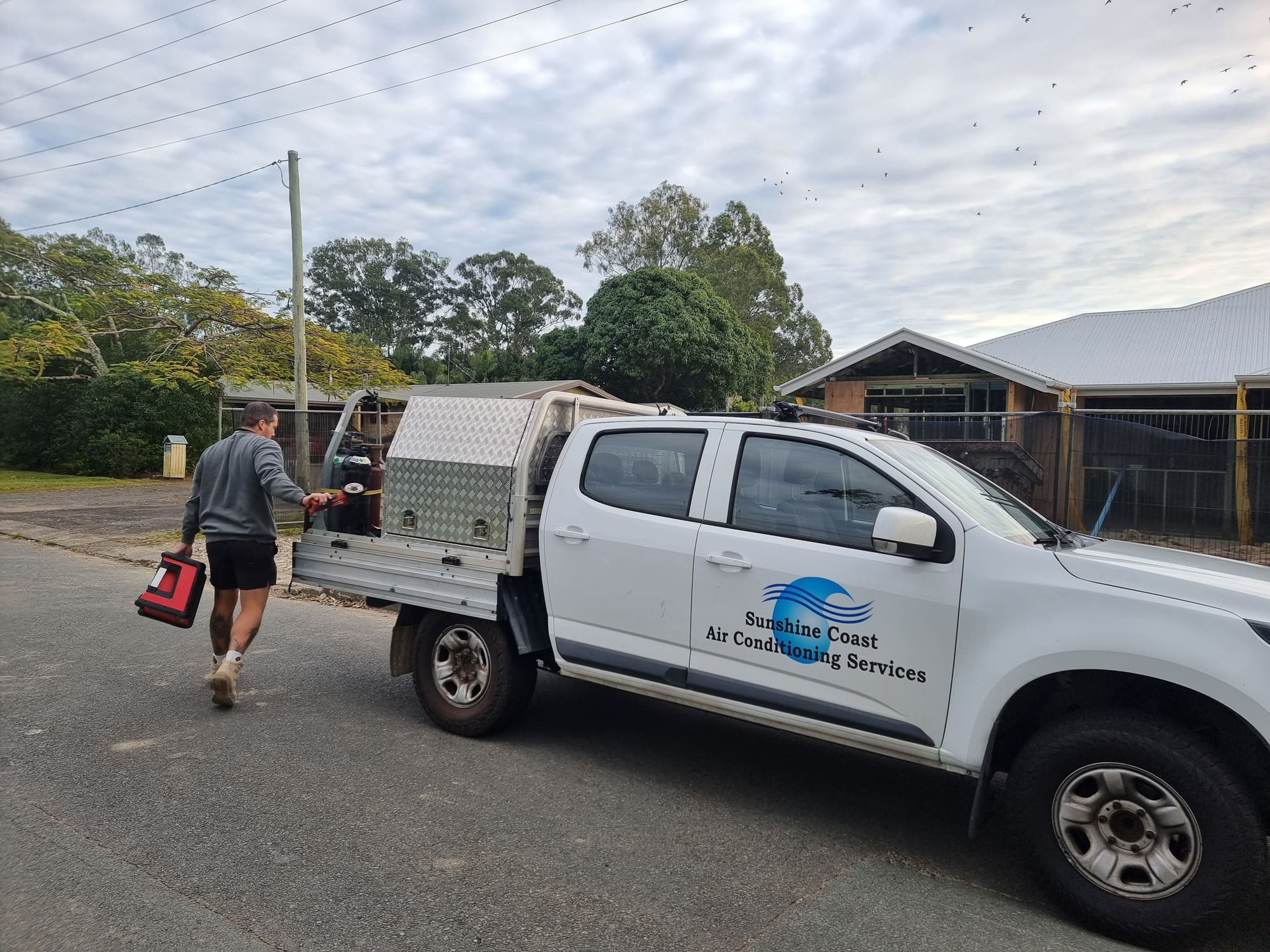 Technician servicing a split system near the coast